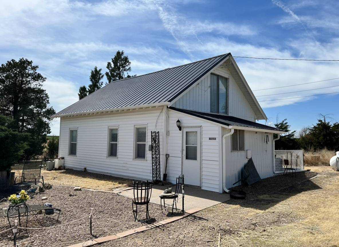 white farm house after standing seam metal roof